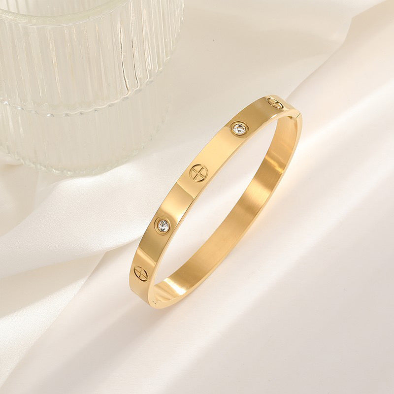 Cartier bangle with Plus sign